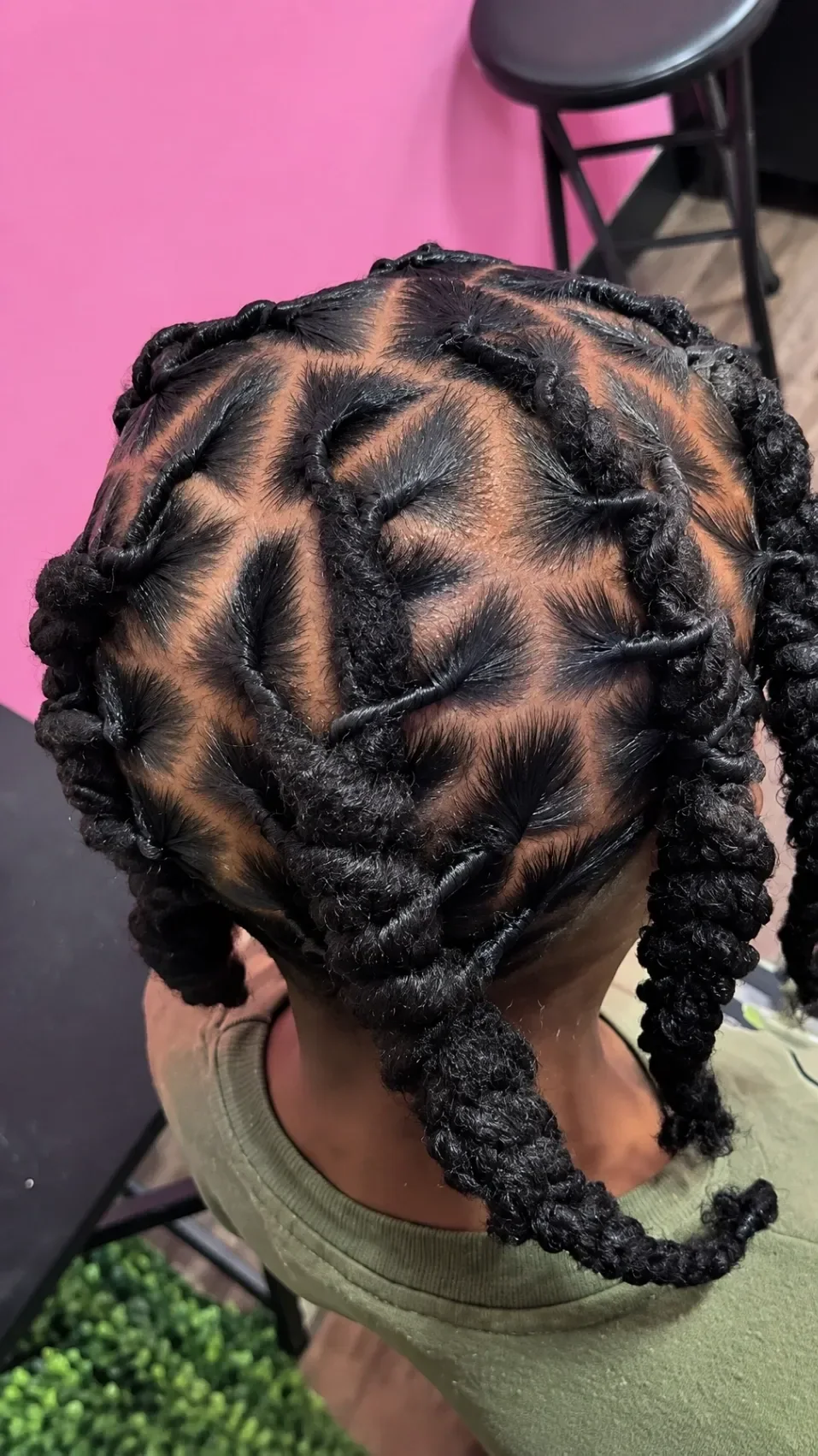 Finished black braided updo with curved parting